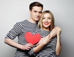 Happy couple in love holding red heart
