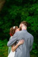 Bride and Groom First Kiss at Wedding Ceremony photo