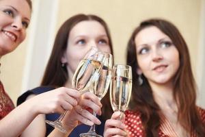 beautiful girls at a Christmas party with glasses of champagne photo