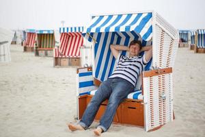 Young happy man on the beach of  North Sea, photo