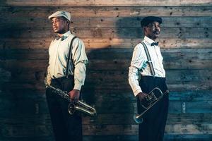 Two african american jazz musicians with trumpet and saxophone. photo