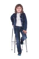 Little girl on the chair in studio