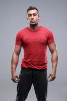 young serious man in red t-shirt