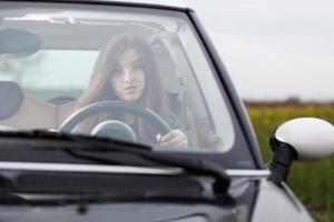 Young beuatiful woman driving a car photo