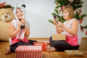 Two girls happy with their christmas gifts photo