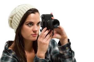 Young woman with brown hair holds camera