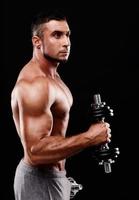 Portrait of a sportsman lifting dumbbells photo