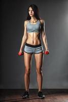 Sports young woman with dumbbells photo