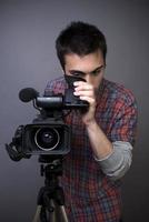 Young man with professional video camcorder