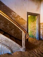 Old staircase in abandoned house of namibian Kolmanskop Ghost Town photo