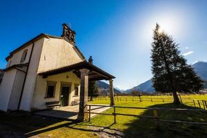church in the meadows of Alps photo