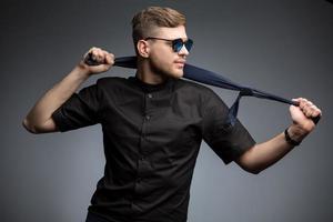 Stylish man in black shirt and mirrored sunglasses