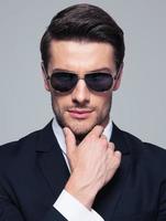 Fashion young businessman in sunglasses photo