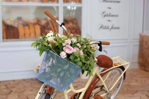 Bicicleta con una cesta de mimbre vintage con rosas foto