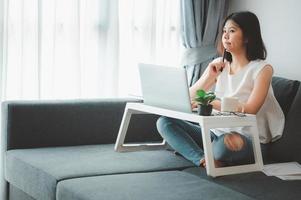 Woman working from home on sofa