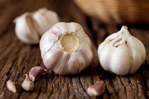 Garlic bulbs on wooden table photo