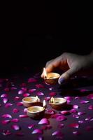 Hand placing candle on bed of petals  photo