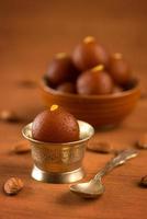 Indian Gulab Jamun dessert on wooden background photo