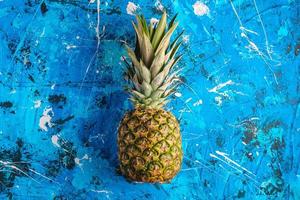 Fresh sweet pineapple on blue textured background