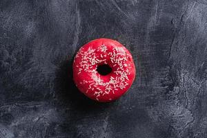 Pink donut with sprinkles, sweet glazed dessert photo