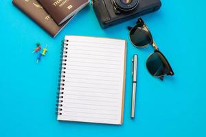 Flat lay of notebook surrounded by travel items  photo