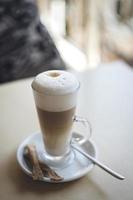 Latte with sugar and spoon photo