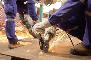 Two male workers cutting metal sheets  photo