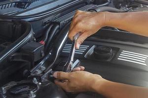 Mechanic works under the hood photo