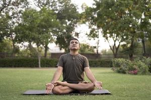 Man doing yoga outdoors photo