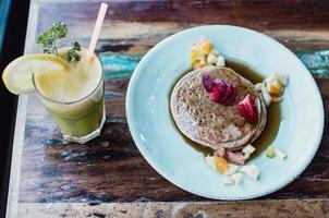 Berry pancakes with green smoothie photo