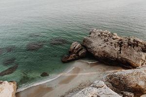 Rock formation on ocean coastline photo