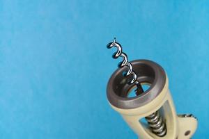 Corkscrew on blue background photo