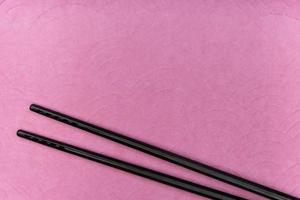 Chopsticks on purple background photo