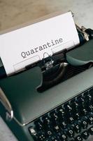 Green typewriter with the word Quarantine typed out photo