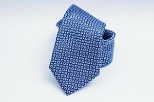 Blue necktie on white surface photo