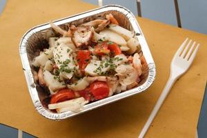 Seafood salad in tinfoil container  photo