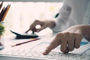 Close-up of bookkeeper calculating or checking balance photo