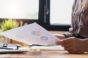 Close-up of businesswoman looking at charts photo