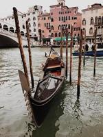 Gondola in water with Rialto Bridge and buildings photo