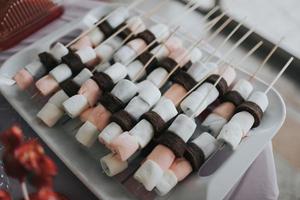 Marshmallow skewers on a plate photo