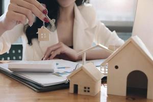 Real estate agent holding house keys photo