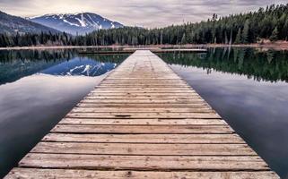 Wooden dock at lake during day