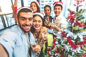 A multiethnic group of people at a holiday party photo