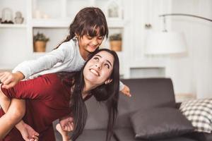 Mother giving daughter a piggyback ride  photo