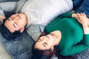 Young  couple relaxing together on living room floor