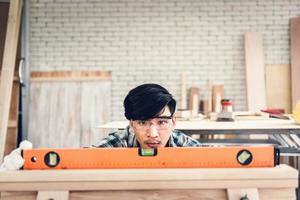 Low angle view of carpenter working in work shop photo