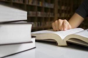 Close up of a person reading at a library photo