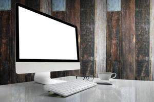 Computer with blank screen on table with blurred background photo