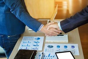 Close-up of two business people shaking hands photo