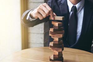 Man building wooden block tower photo